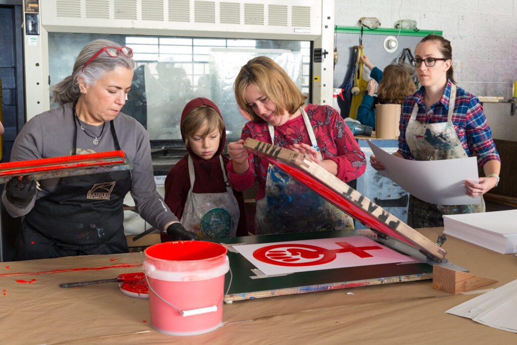 Seattle, Washington: Beth Anderson demonstrates proper screen printing technique in the print studio. Supporters turned out in droves at the Screen Printing Work Party on Saturday for the Womxn's March on Seattle. Led by artists Kristen Ramirez and Claire Jauregui at the Pratt Fine Arts Center print studio, supporters were invited to come and help make positive resistance poster prints for the upcoming Womxn's March on Seattle. The march will be held on January 21, 2017 in solidarity with the national Women’s March on Washington D.C.