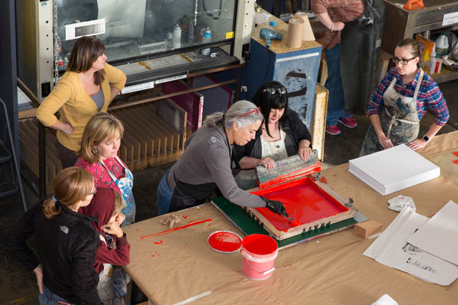 Seattle, Washington: Beth Anderson demonstrates proper screen printing technique in the print studio. Supporters turned out in droves at the Screen Printing Work Party on Saturday for the Womxn's March on Seattle. Led by artists Kristen Ramirez and Claire Jauregui at the Pratt Fine Arts Center print studio, supporters were invited to come and help make positive resistance poster prints for the upcoming Womxn's March on Seattle. The march will be held on January 21, 2017 in solidarity with the national Women’s March on Washington D.C.